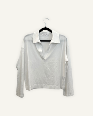Blusa Valentino Rama liquida con scollo a polo profondo